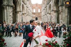 Bride and Groom share a tender first kiss at San Galgano Abbey in Siena, surrounded by the history of the stunning Agriturismo San Galgano.